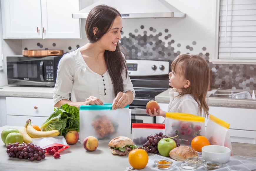 Women cooking healthy food with child.