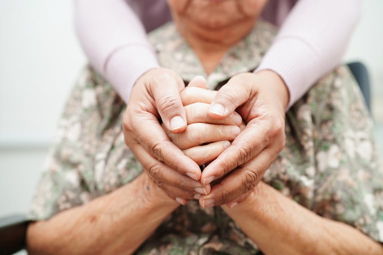 holding a loved one's hand at the end of life