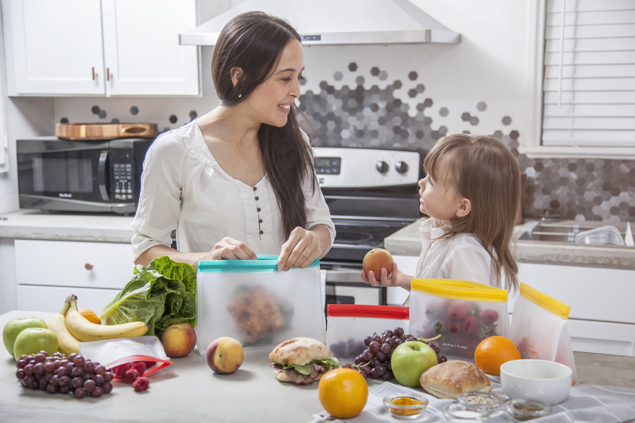 Women cooking healthy food with child.